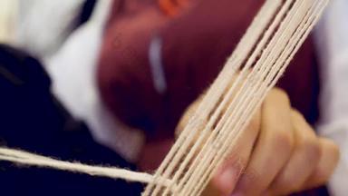 特写镜头女士手编织传统的编织机首页编织机细节传统的古董编织手织机羊毛关闭传统的织机少数民族服装
